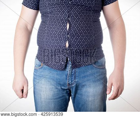 A Man In A Black Tight Shirt On A White Background. Overweight, Unhealthy Diet And Weight Loss Conce
