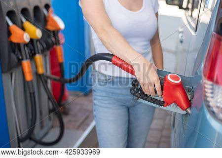 Caucasian Woman Refueling A Car At A Self-service Gas Station.