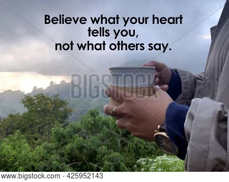 Nspirational Quote - Believe What Your Heart Tells You, Not What Others Say. With Hand Of A Person H