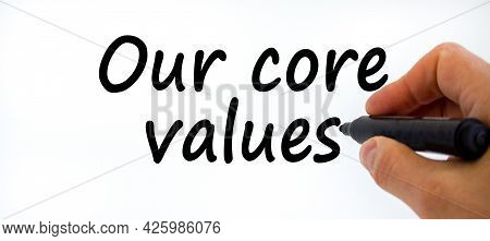Our Core Values Symbol. Businessman Writing 'our Core Values', Isolated On White Background. Busines
