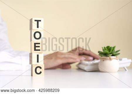 Pyramid Of Wooden Cubes With The Word Toeic, Concept