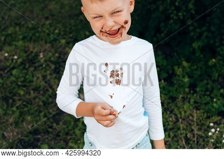 Boy Showing Chocolate Stains On White Clothes, Dirt On His Face