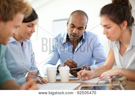 Young business people meeting around table
