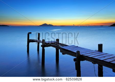 Wooden bridge with seascape during sunet