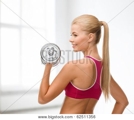 fintess, healthcare and dieting concept - young sporty woman with heavy steel dumbbell