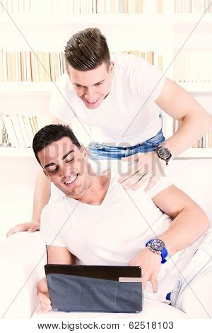 Cheerful Young People Looking At Laptop And Having Fun