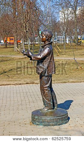 Monument To Boy Photographer With A Camera From Which A Bird Flies