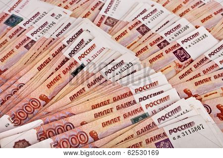 Heap of five thousand Russian rubles banknotes surface top view background 
