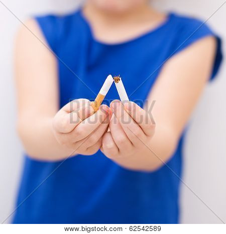 Young Girl Is Breaking A Cigarette