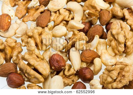 mixed nuts - hazelnuts walnuts cashews pine nuts isolated on white background