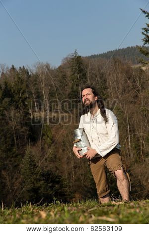 Medieval Farmer With Milk Can In The Nature