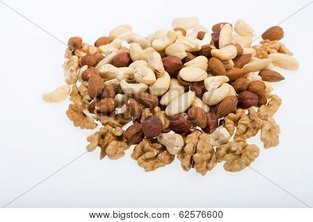 mixed nuts - hazelnuts walnuts cashews pine nuts isolated on white background