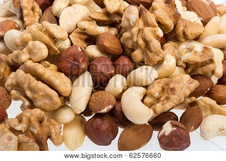 mixed nuts - hazelnuts walnuts cashews pine nuts isolated on white background