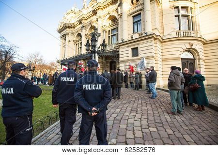 KRAKOW, POLAND - MAR 9, 2014: Unidentified participants during protest near Cracow Opera, against bringing Russian troops in the Crimea. Posters: Ukraine without Putin, and Putin - Thief.