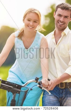 Happy Couple Having Fun Together Riding Bike Outdoors