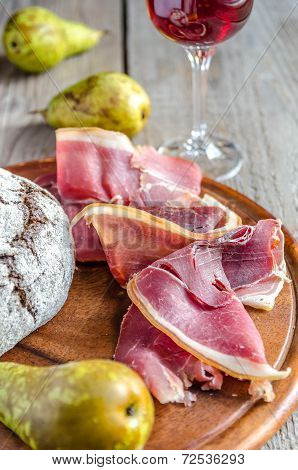 Slices Of Italian Ham On The Wooden Board