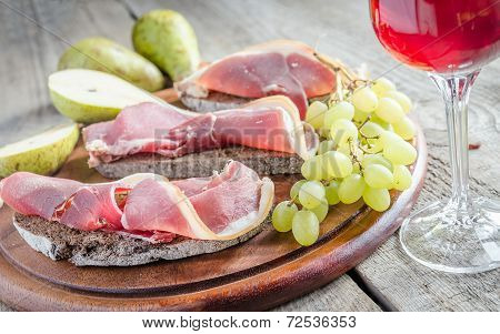 Sandwiches With Italian Ham On The Wooden Board