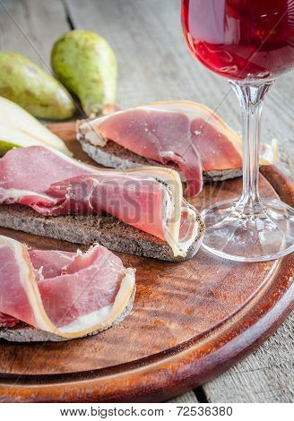 Sandwiches With Italian Ham On The Wooden Board