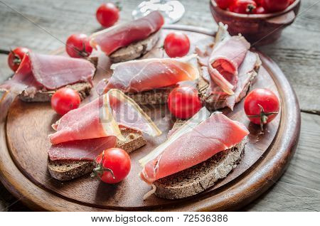 Sandwiches With Italian Ham On The Wooden Board