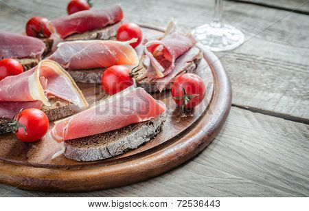 Sandwiches With Italian Ham On The Wooden BoardBoard