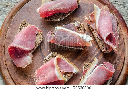 Sandwiches With Italian Ham On The Wooden Board