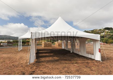 White Tents In A Dry Field Outdoors