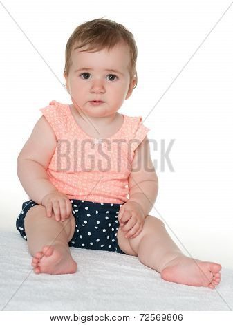 Baby Girl Sits On The White Towel