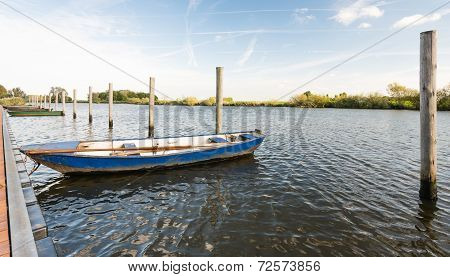Moored Iron Rowing Boat In Rippling Water