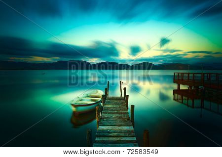 Wooden Pier Or Jetty And A Boat On A Lake Sunset. Versilia Tuscany, Italy