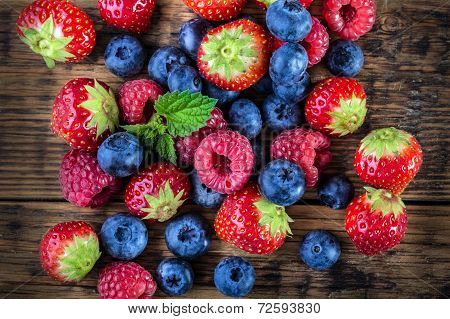 Berry fruits on wooden background