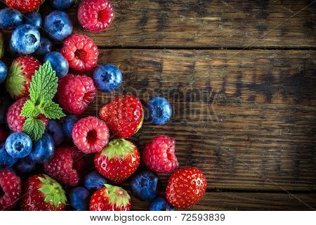 Berry fruits on wooden background