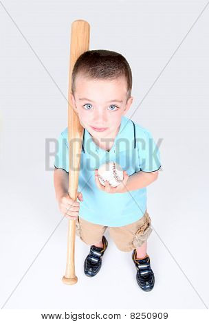Young Boy Holding A Baseball Bat And Ball