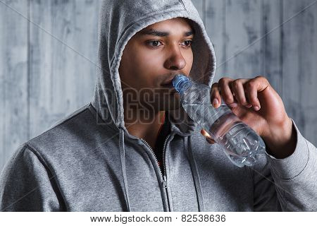 African athlete in the studio with water