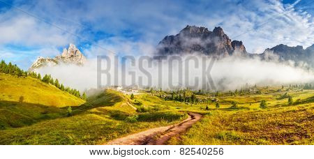 Great view of the foggy Tofane mountain range from Falzarego pass. National Park. Dolomites (Dolomiti), South Tyrol. Location Cortina d'Ampezzo. Italy, Europe. Dramatic scene. Beauty world.