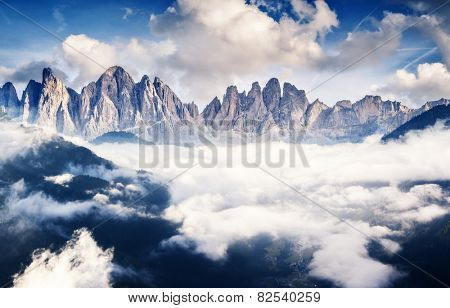 Great view of the foggy Val di Fassa valley with pass Sella. National Park. Dolomites (Dolomiti), South Tyrol. Location Canazei, Campitello, Mazzin. Italy, Europe. Dramatic scene. Beauty world.