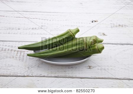 fresh lady finger on thw wooden table