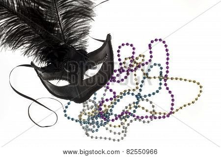 Shiny Gold, Purple, Blue And Silver Beads And Mardi Gras Mask With Feathers On A White Background. S