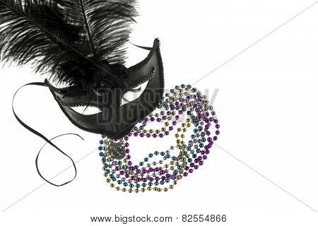 Shiny Gold, Purple, Blue And Silver Beads And Mardi Gras Mask With Feathers And Fleur D'lys On A Whi