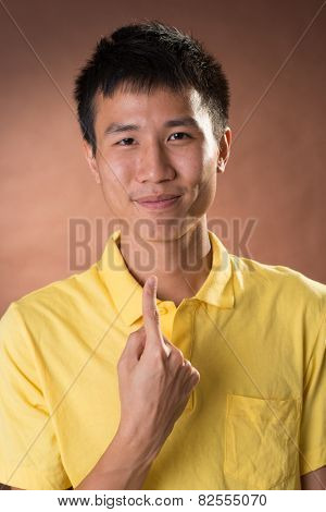 Cheerful young Chinese guy pointing at himself, closeup portrait in studio.