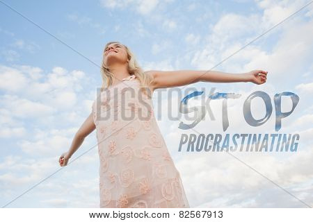 Young woman in summer dress stretching arms against sky against stop procastinating