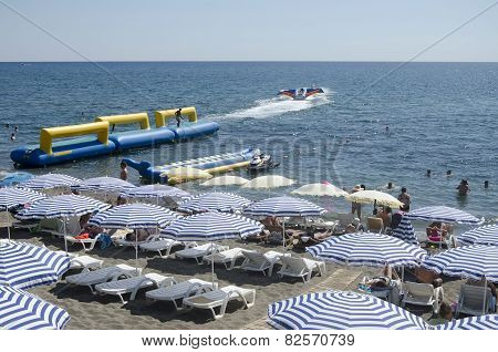 Resting Under A Sun Umbrella On The Beach