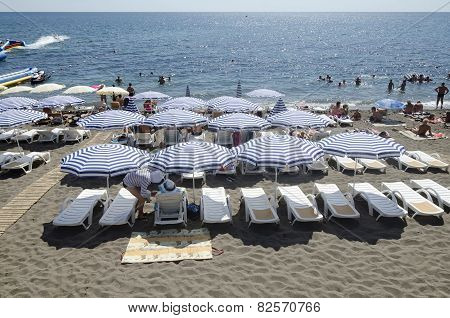Resting Under A Sun Umbrella On The Beach