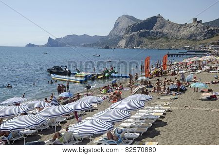Tourists On The Beach In Sudak In The Crimea