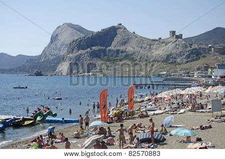 Tourists On The Beach In Sudak In The Crimea