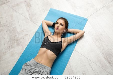 Portrait of attractive woman resting on the yoga mat