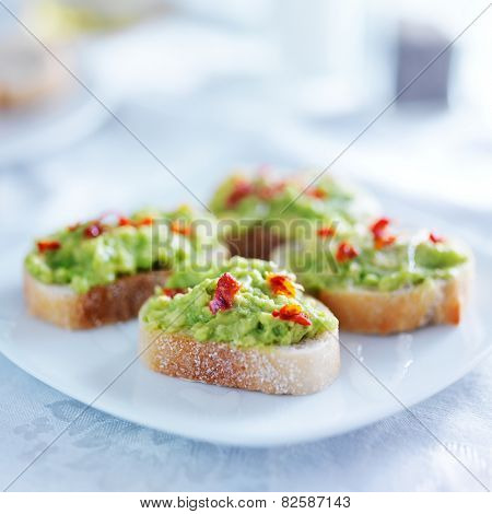 spicy avocado spread on toasted crustini