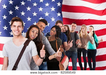College Students Gesturing Thumbs Up In A Line
