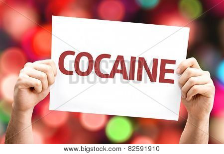 Cocaine card with colorful background with defocused lights