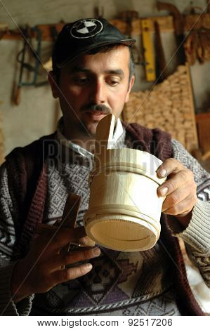 Carpenter Handcrafting A Wooden Alpenhorn