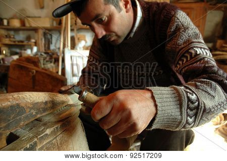 Carpenter Handcrafting A Wooden Alpenhorn